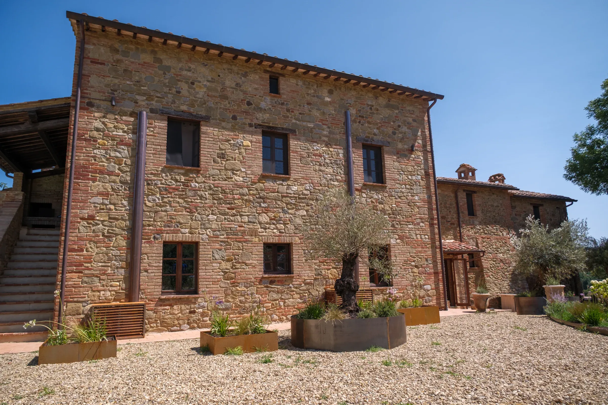 Main villa façade with an olive tree