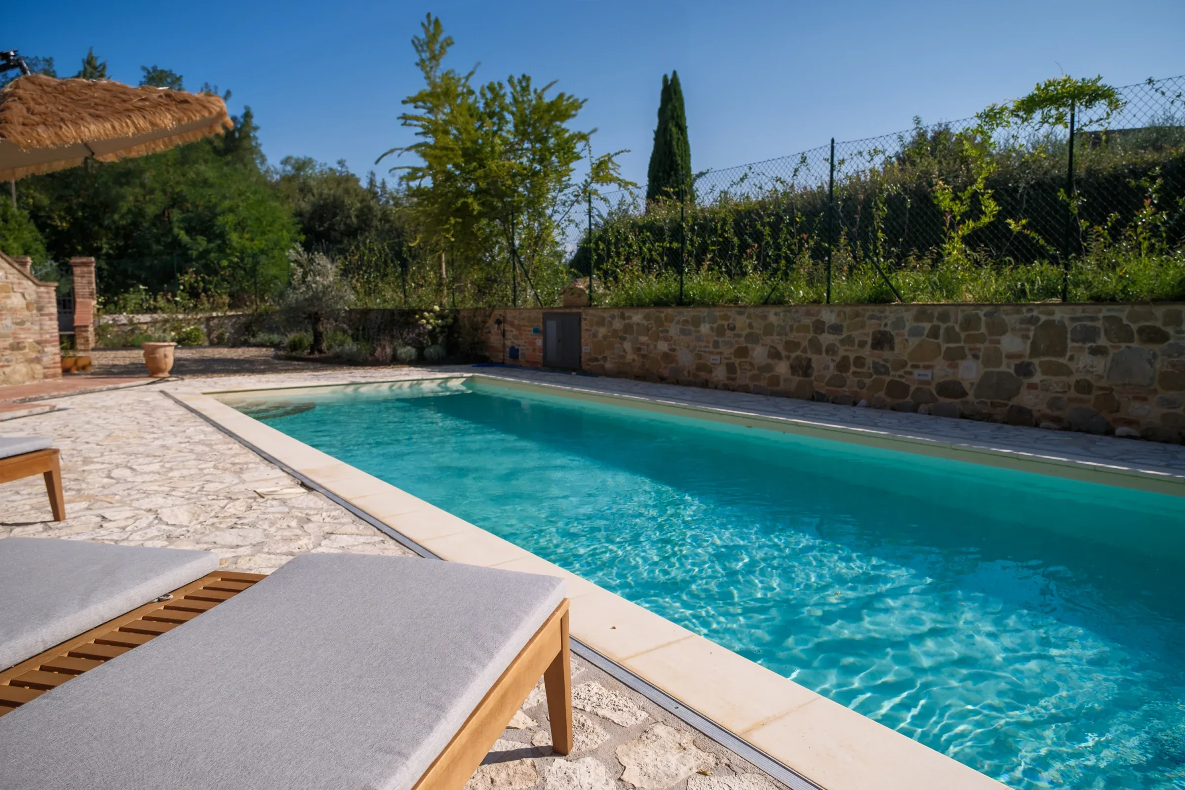 Turquoise pool seen from a sun lounger