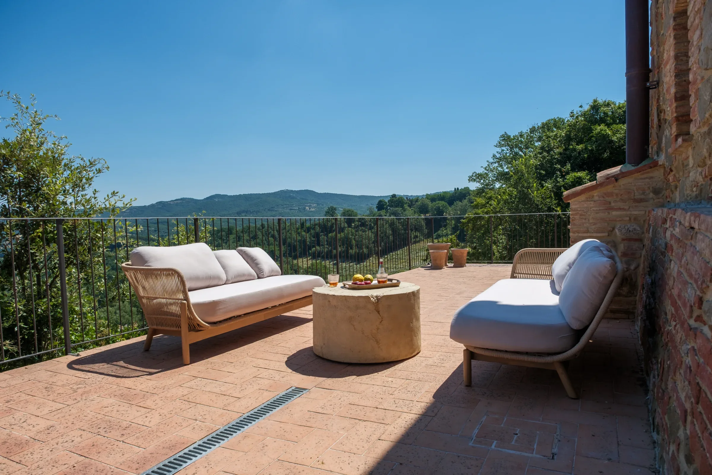 Terrace lounge beside the stone façade
